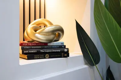 a stack of books with a gold donut on top at Stylish Preston Home 3 Beds Sleeps 6 in Preston