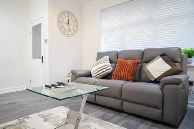 a living room with a couch and a glass table at Stylish Preston Home 3 Beds Sleeps 6 in Preston