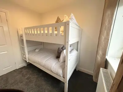 a white bunk bed in a room at Dalton House - Private Parking in Blackpool