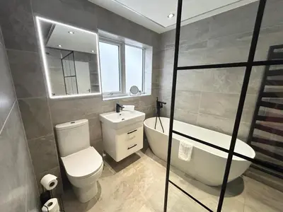 a bathroom with a toilet and a tub and a sink at Dalton House - Private Parking in Blackpool