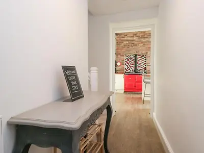 a room with a table with a sign on it at No 2 The Flags in Grange Over Sands