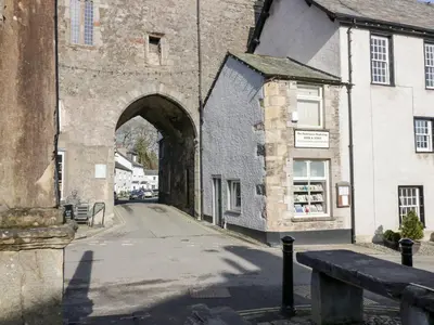 an old building with an archway in a street at No 2 The Flags in Grange Over Sands