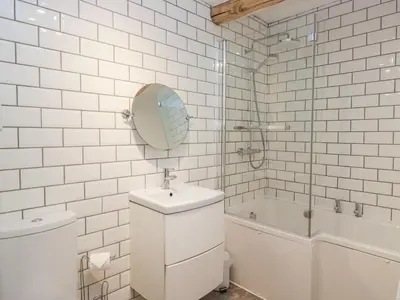 a bathroom with a toilet and a sink and a tub at No 2 The Flags in Grange Over Sands