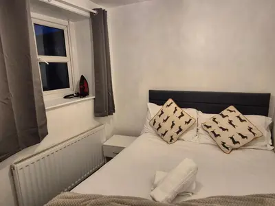 a bedroom with a white bed with pillows and a window at Peaceful Home in Hermitage Street Rishton in Rishton