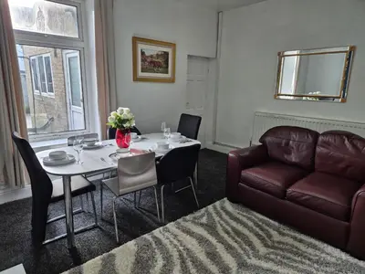 a living room with a table and a couch at Peaceful Home in Hermitage Street Rishton in Rishton