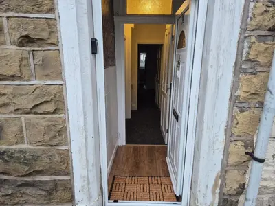 a hallway of a home with a stone wall at Peaceful Home in Hermitage Street Rishton in Rishton
