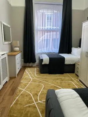 a bedroom with two beds and a window at A Comfy Stay Close to City-Centre in Preston