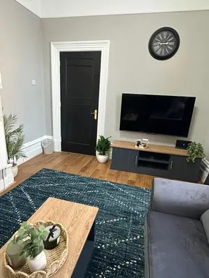 a living room with a couch and a tv at A Comfy Stay Close to City-Centre in Preston