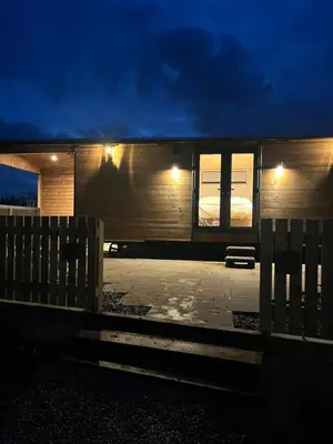 a tiny house with a bedroom and a fence at Mill House Farm Pods- Kingfisher in Pilling