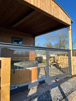 a glass window of a building with a table at Mill House Farm Pods- Kingfisher in Pilling