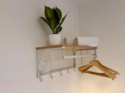 a shelf on a wall with a plant on it at 4 Bed - Parking - Fast WiFi - Desk - M6 M61 links - Pets in Leyland