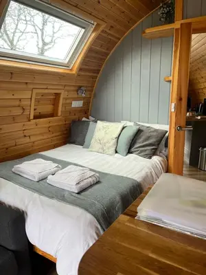 a large bed in a room with a window at Mill House Farm Pods - Mallard View in Pilling