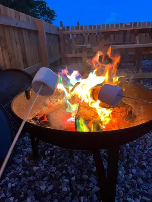 a fire pit with two utensils around it at Mill House Farm Pods - Mallard View in Pilling