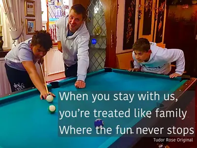 a woman and two boys playing pool with a message at MyRoomz Tudor Rose Original in Blackpool