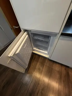 an empty refrigerator door is open in a kitchen at Stunning City View Studio Apartment by StaySavvy Accommodation in Liverpool
