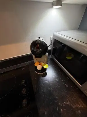 a coffee maker is standing next to a microwave at Stunning City View Studio Apartment by StaySavvy Accommodation in Liverpool