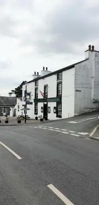 a white building on the side of a street at George Washington Inn in Carnforth