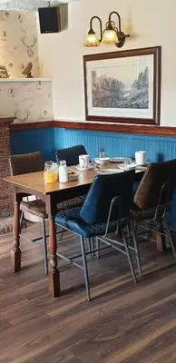 a wooden table and chairs in a room at George Washington Inn in Carnforth