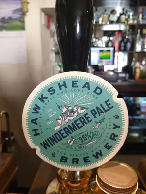a sign for awaukeeheastern universitymage plate on a counter at George Washington Inn in Carnforth