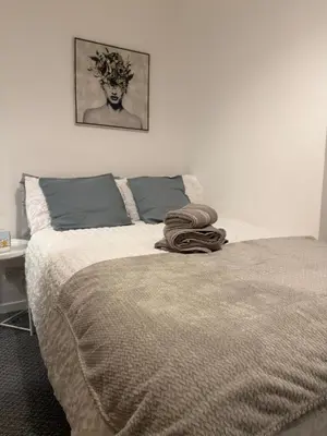 a bedroom with a bed with a blanket on it at Cosy Double and Triple Bedrooms 5 minutes from Anfield Stadium in Liverpool