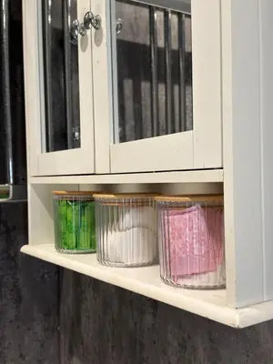 a shelf with four bowls in a cabinet at Cosy Double and Triple Bedrooms 5 minutes from Anfield Stadium in Liverpool