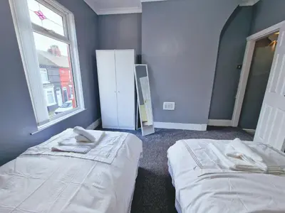 a room with two beds and a window at Stylish Modern Home comfy setting by Everton Park in Liverpool