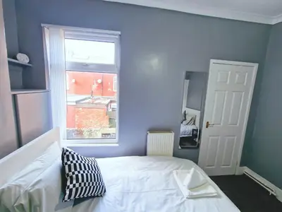 a bedroom with a white bed and a window at Stylish Modern Home comfy setting by Everton Park in Liverpool