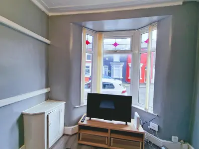 a living room with a tv and a window at Stylish Modern Home comfy setting by Everton Park in Liverpool