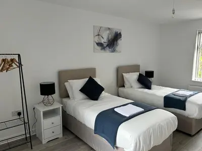 two beds in a room with white walls at Contractors, Discounts, Free Parking, 4 BR, Sleep7 in Bidston