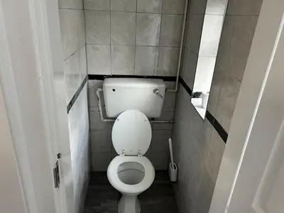 a small bathroom with a toilet in a stall at Contractors, Discounts, Free Parking, 4 BR, Sleep7 in Bidston