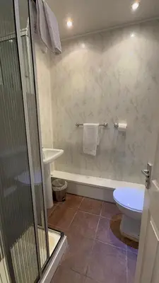 a bathroom with a shower and a toilet and a sink at No 34 Vance Road in Blackpool