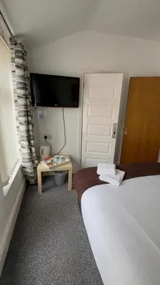 a bedroom with two beds and a tv on the wall at No 34 Vance Road in Blackpool