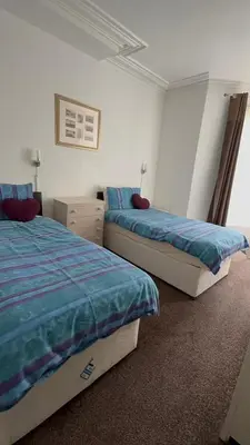 a bedroom with two beds and a window at No 34 Vance Road in Blackpool