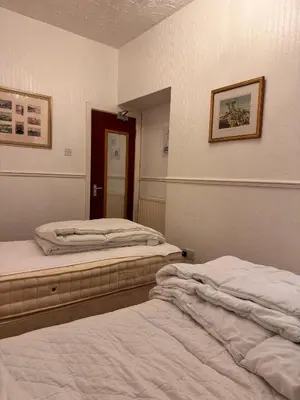 a room with two beds and a mirror at No 34 Vance Road in Blackpool