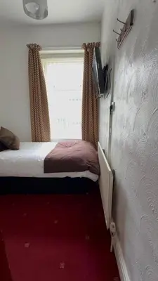 a small bedroom with a bed and a window at No 34 Vance Road in Blackpool