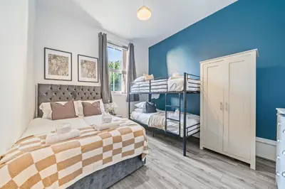 a bedroom with a bed and a bunk bed at Latimer Flat 1 - Spacious 2-Bed Apt - Sleeps 7 - Ground Flr in Liverpool