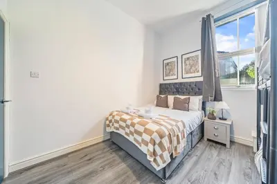a bedroom with a bed and a window at Latimer Flat 1 - Spacious 2-Bed Apt - Sleeps 7 - Ground Flr in Liverpool