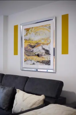 a living room with a couch and a painting on the wall at Prestige Short Stay in Liverpool