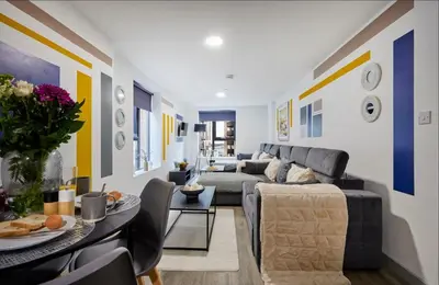 a living room with a couch and a table at Prestige Short Stay in Liverpool