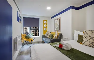 a bedroom with a bed with a swan on it at Prestige Short Stay in Liverpool