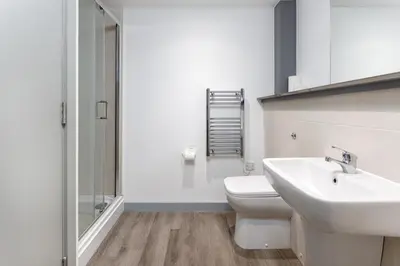a bathroom with a white toilet and a sink at Prestige Short Stay in Liverpool