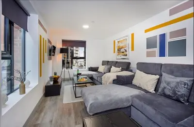 a living room with a couch and a table at Prestige Short Stay in Liverpool