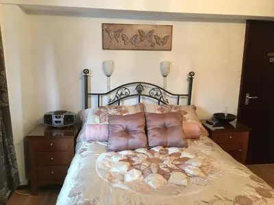a bed with a bunch of pillows on it at smithy lodge guest house in Leyland