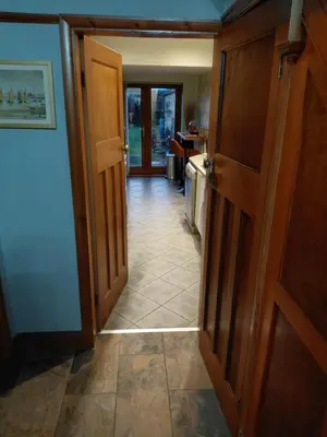 a hallway with an open door to a kitchen at Penwortham traditional home in Penwortham