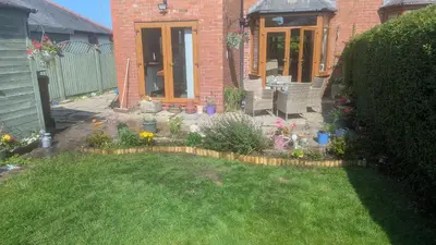 a backyard with a garden with flowers and plants at Penwortham traditional home in Penwortham