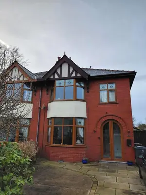 a red brick house with a large window at Penwortham traditional home in Penwortham