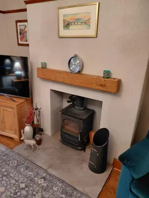 a living room with a fireplace with a stove at Penwortham traditional home in Penwortham