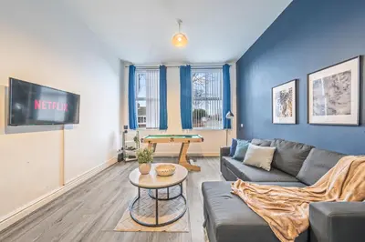 a living room with a couch and a table at Latimer Flat 2 - Spacious 2-Bed Apt - Sleeps 7 in Liverpool