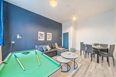 a living room with a couch and a pool table at Latimer Flat 2 - Spacious 2-Bed Apt - Sleeps 7 in Liverpool