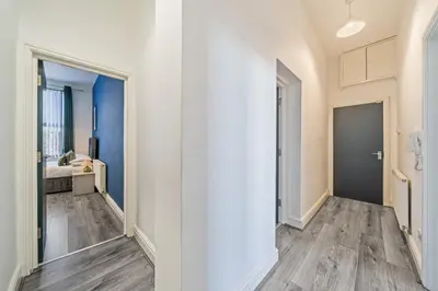 a hallway with white walls and wooden floors at Latimer Flat 3 - Spacious 2-Bed Apt - Sleeps 6 in Liverpool